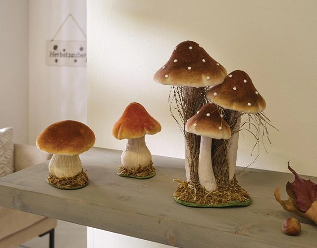 Décoration d'automne : des champignons en céramique marron et crème, une touche naturelle sur une étagère en bois